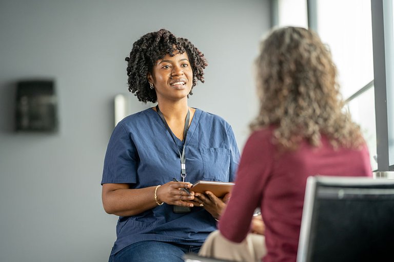 Home care professional reviewing notes with a colleague